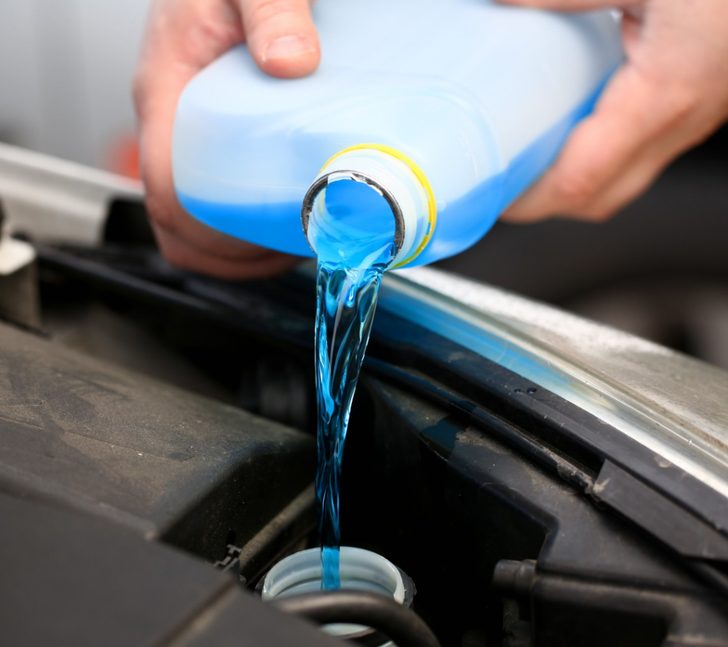 What are the advantages of using windshield washer fluid over water